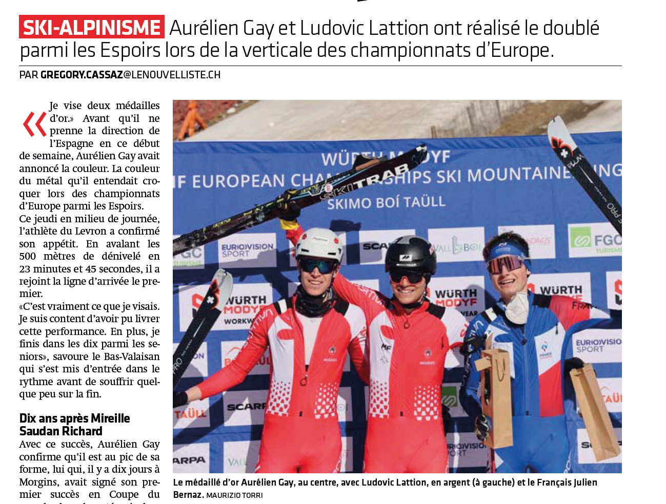Photo of a man giving a talk on stage with blue curtains behind him.